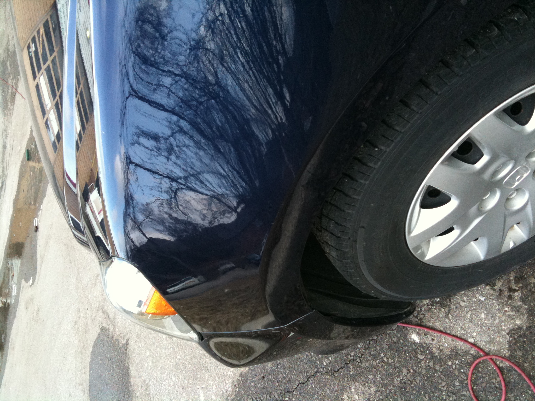 After round dent in front fender repaired