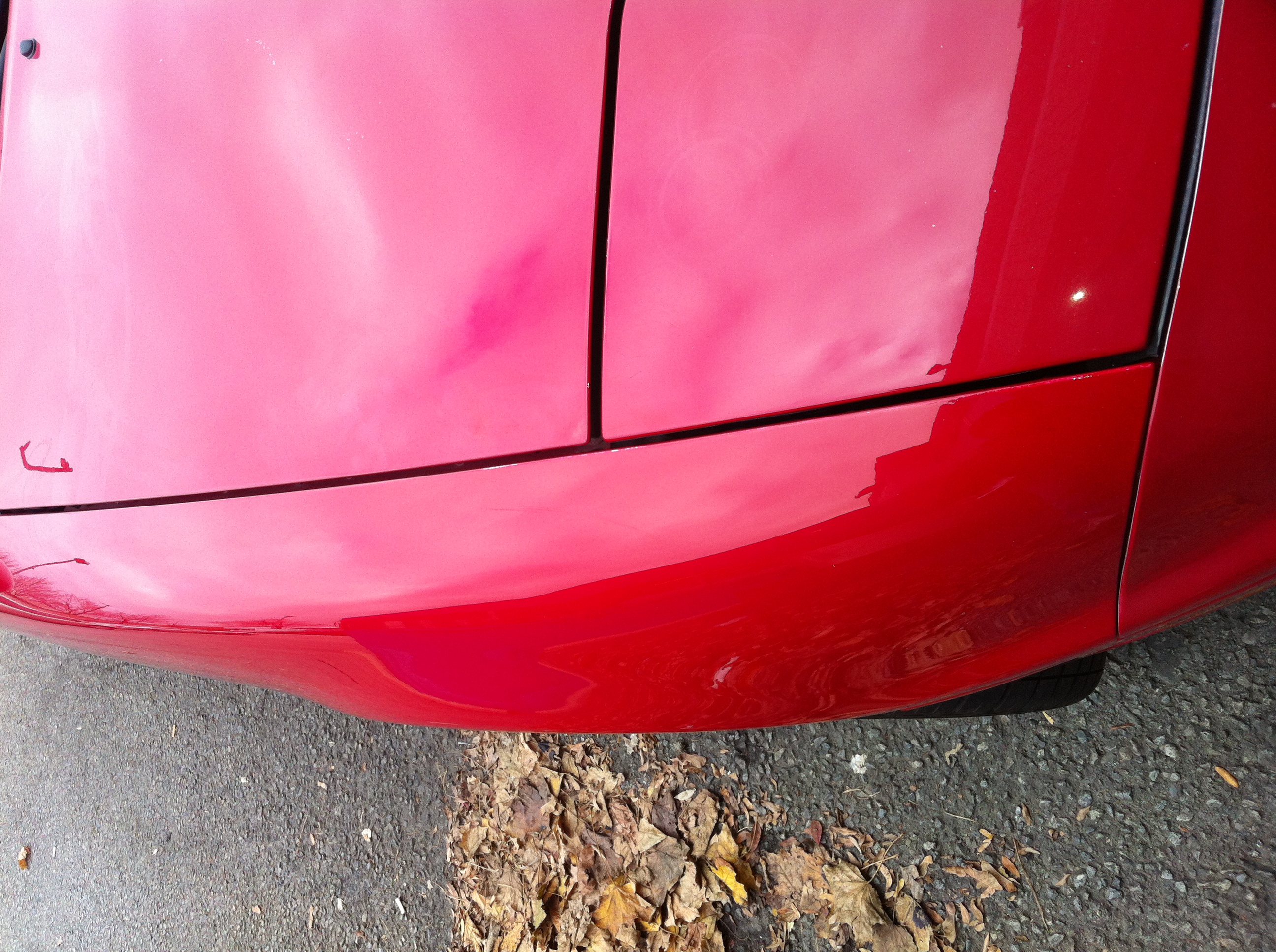 After rear bodyline dent repair on red panel