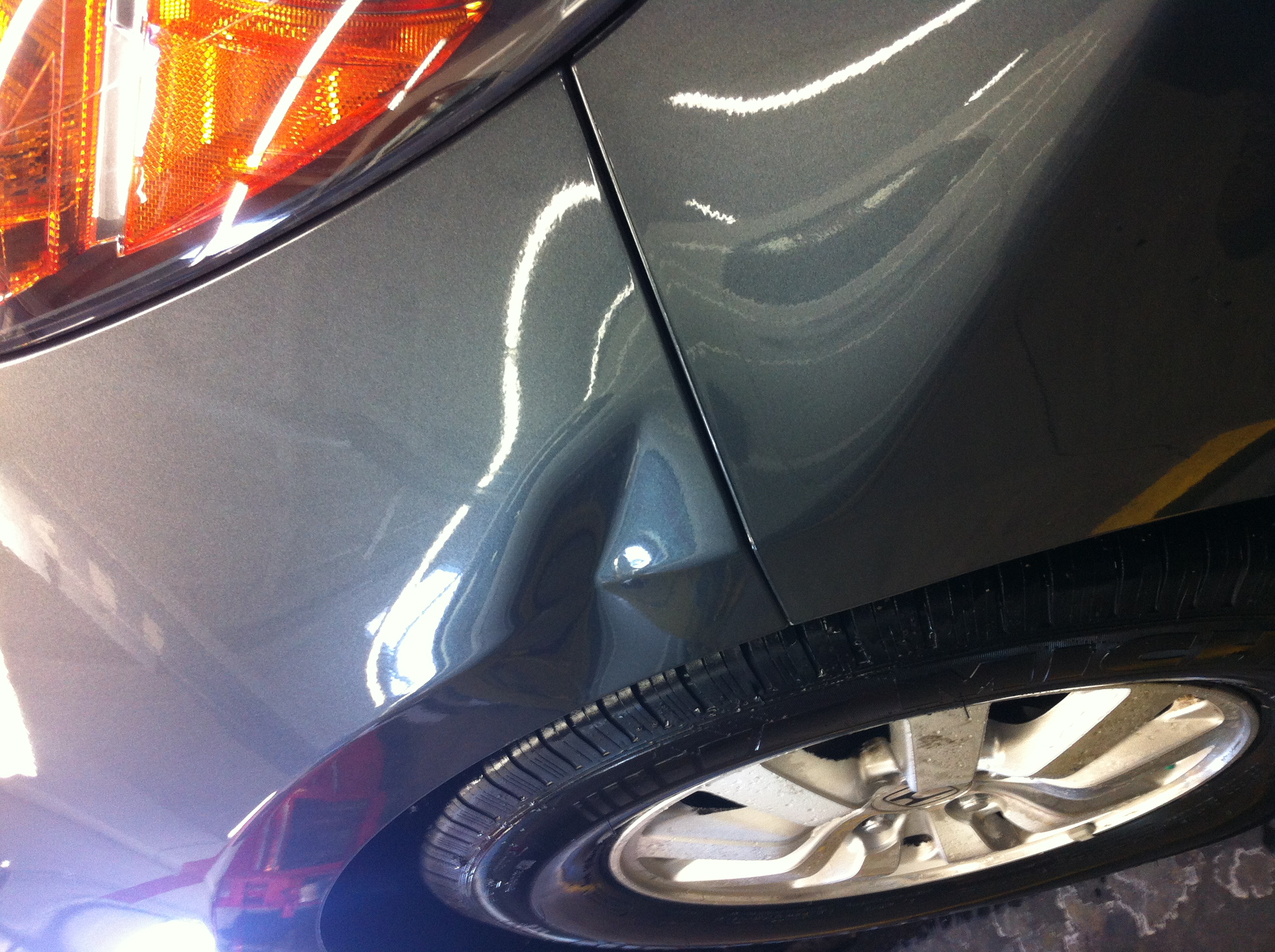 Before quarter panel dent near taillight